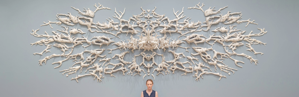 Courtney Mattison with her “Malum Geminos” (2019), which she adapted for “Turn the Tide.” The title was inspired by biologist Jane Lubchenco’s reference to the “evil twins” of climate change and ocean acidification in causing coral reefs to sicken, bleach and erode. Credit: Courtney Mattison/Florence Griswold Museum