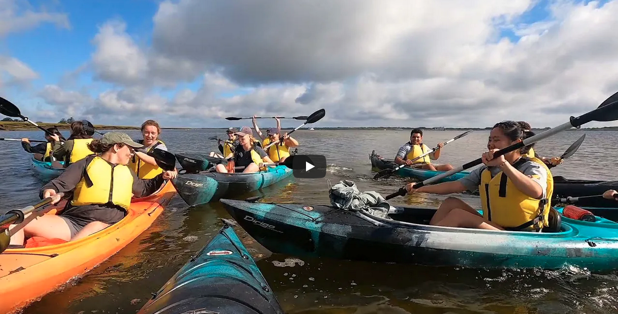 students laughing in kayaks