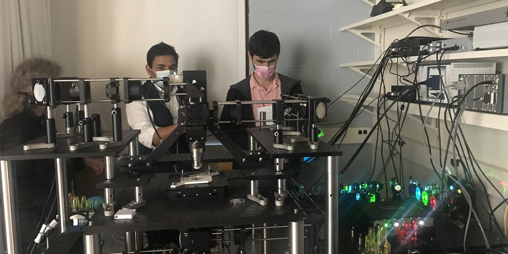 Abhishek Kumar (center) with microscope