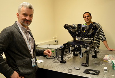 Patrick La Riviere, left, and Hari Shroff with the diSPIM system (Dual-view Selective Plane Illumination Microscopy) in the MBL's Lillie Laboratory. Note the two objectives mounted at right angles above the sample. A light sheet is created from one objective and imaged through the other objective. A stack of images is created by moving the light sheet through the sample. Especially useful for live-cell imaging and developmental biology, the system provides rapid 3D imaging with low phototoxicity to samples.