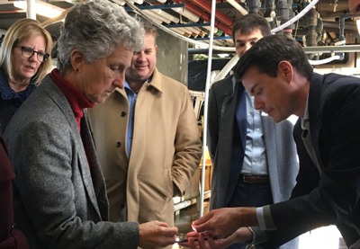 Rep. Sarah Peake, a member of the Massachusetts Ocean Acidification commission, and MBL's Sebastien Laye illuminate a skate egg case in the MBL's Marine Resources Center. Credit: Jane Marks