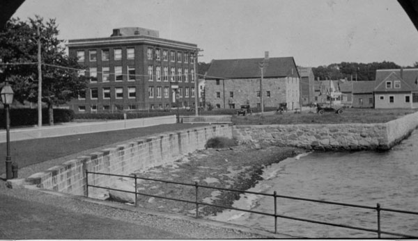 Looking east down Water Street: Crane Building, Candle House and the MBL Club in 1919.