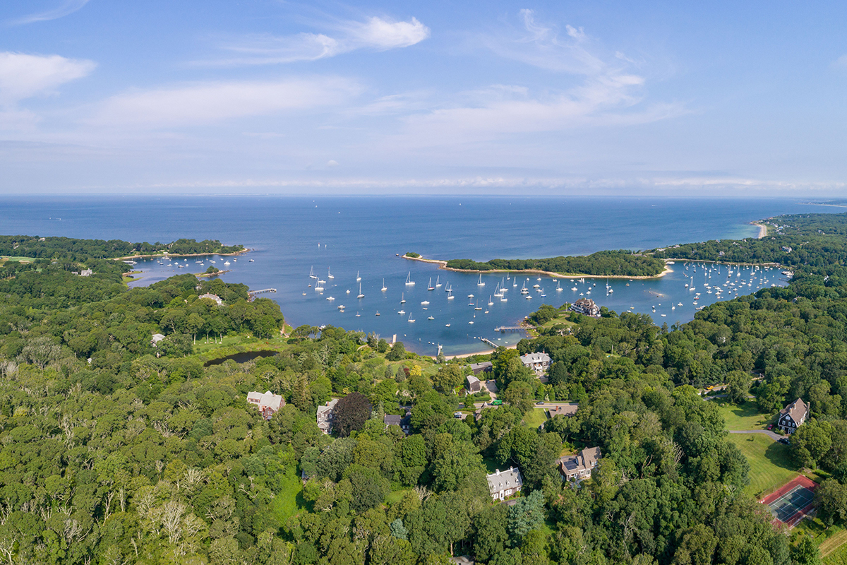 Aerial view of The Knob and Quissett Harbor in Woods Hole, with greater Buzzards Bay in the distance. Buzzards Bay is approximately 28 miles long by 8 miles wide and is a popular destination for fishing, boating, and tourism. Credit: Fish Hawk Films