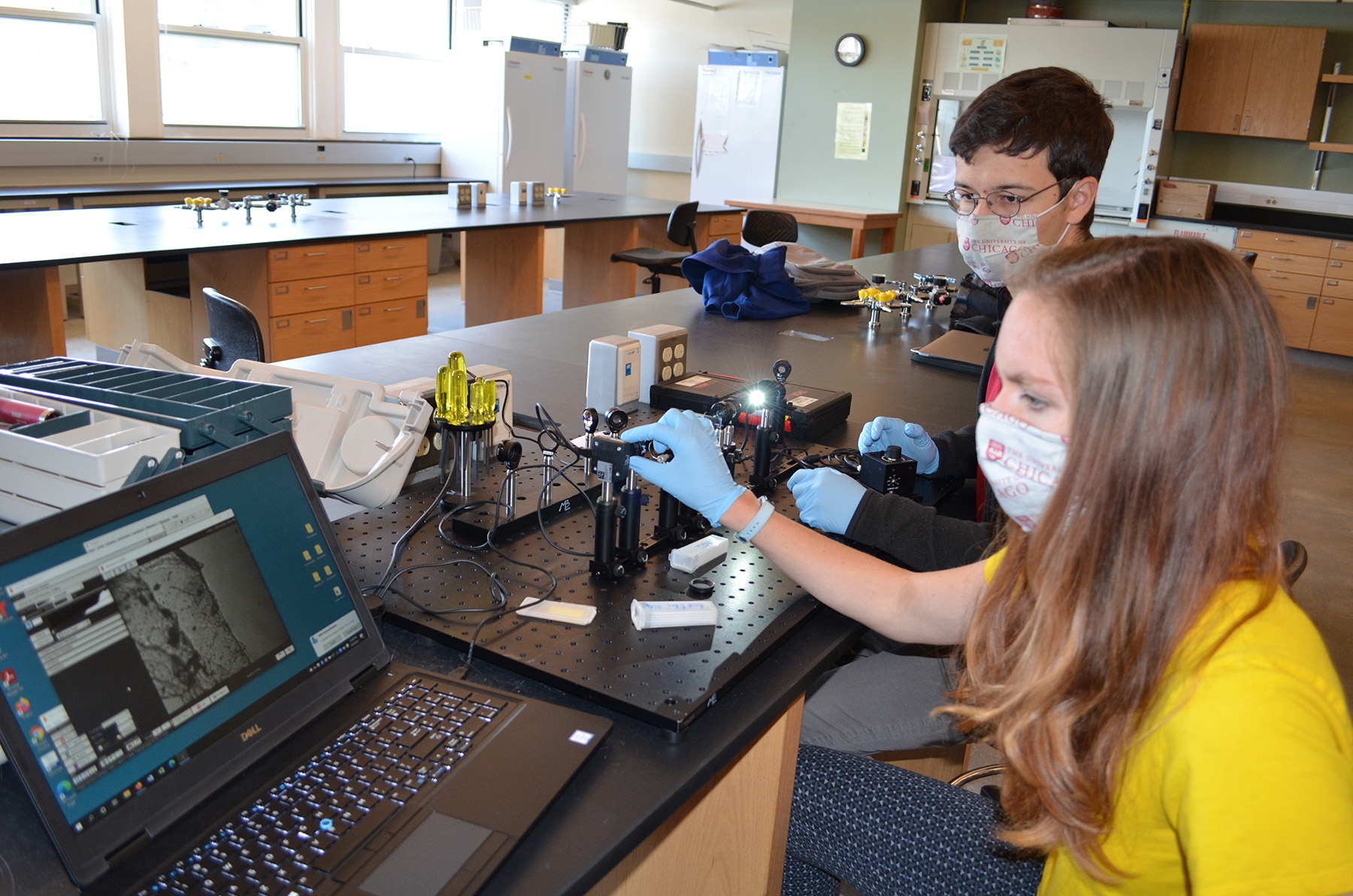 Isabel O’Malley Krohn and Nichos Molnar build a microscope on rails during the Optics, Waves, and Modern Physics course. Credit: Diana Kenney