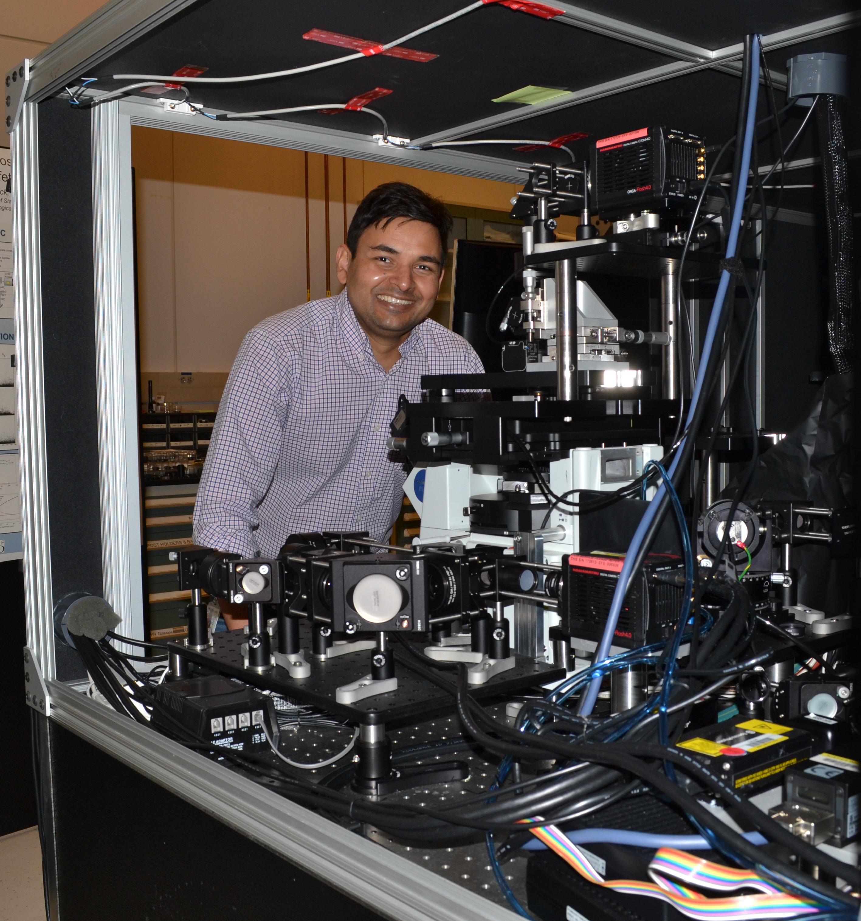 Abhishek Kumar with a super-resolution optical microscope he built in collaboration with James Marr of the National Institute of Standards and Technology. Credit: Anthony Mautino
