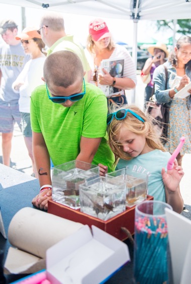 Cameron Duquette, 10, and Emily Duquette, 6, look at catshark, squid, and skate embryos