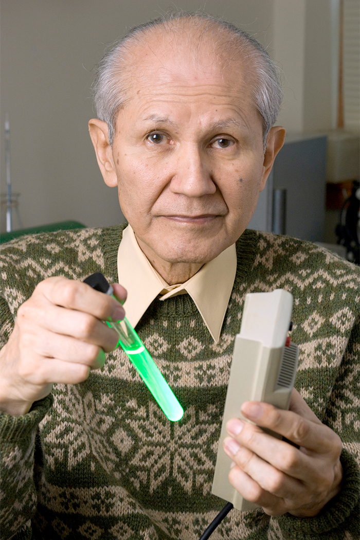 Osamu Shimomura holds a test tube containing green fluorescent protein (GFP)