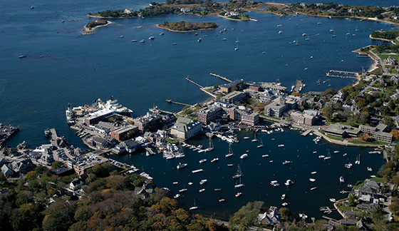 Aerial photo of Woods Hole, Great Harbor and Eel Pond (lower left). MBL buildings located around Eel Pond identified as being at higher risk of flooding include Lillie Laboratory (brick complex at center), the Marine Resources Center to the left of Lillie, and the grey Swope Conference Center complex at far right. Credit: Marine Biological Laboratory