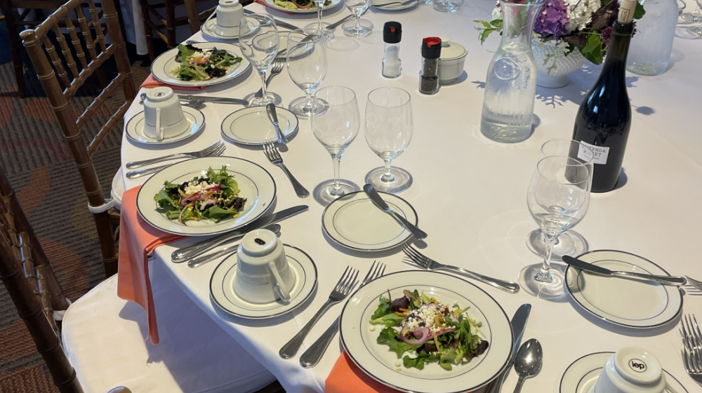 Round table with place settings and decoration.