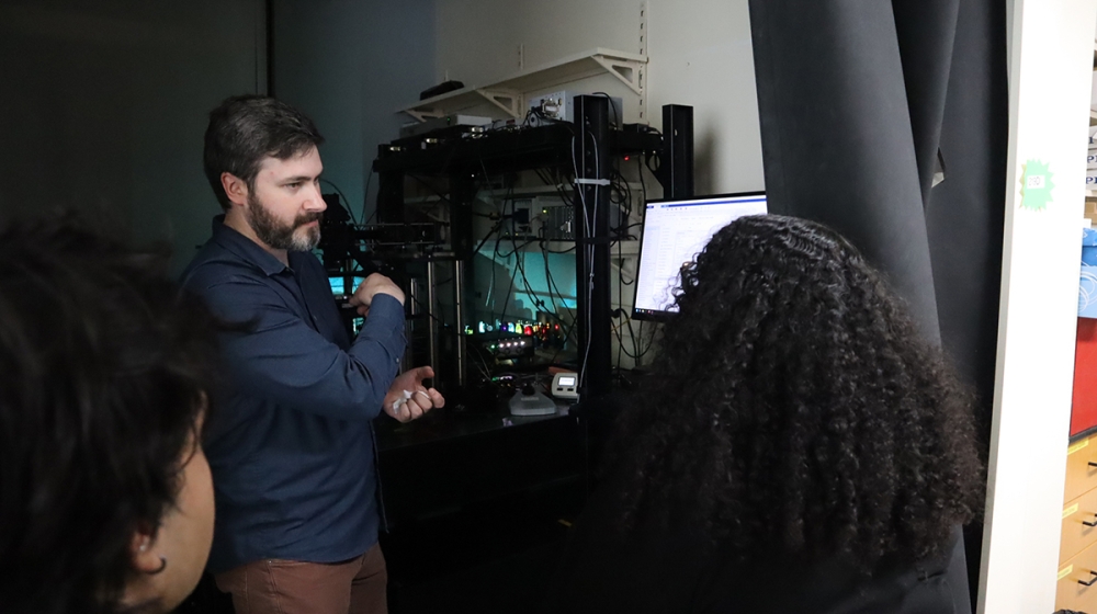MBL Research Scientist Matthew Parent trains students Erick Torres-Guasp (left) and Amina Bradley (right) on a custom dual-view line-scanning confocal microscope in the MBL’s Imaging Innovation Center.