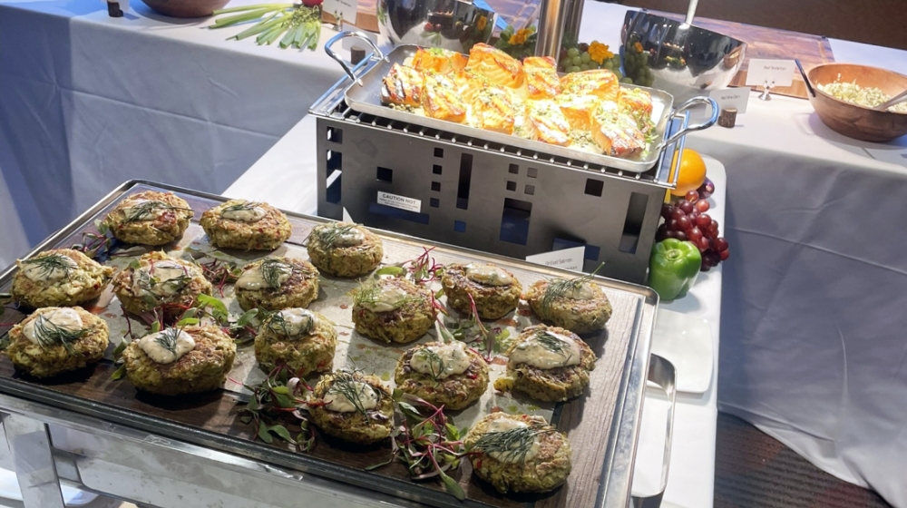 A dinner station with patties and fish.