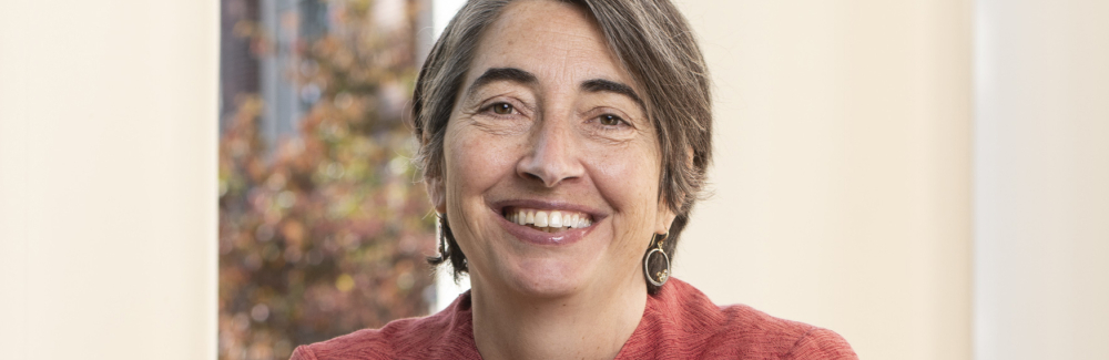 Head and shoulders professional image of Alexandra Z Worden, a scientist wearing a pink jacket