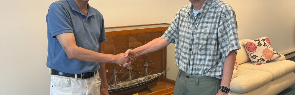 Nipam Patel (left) shaking hands with Mark Terasaki (right) 