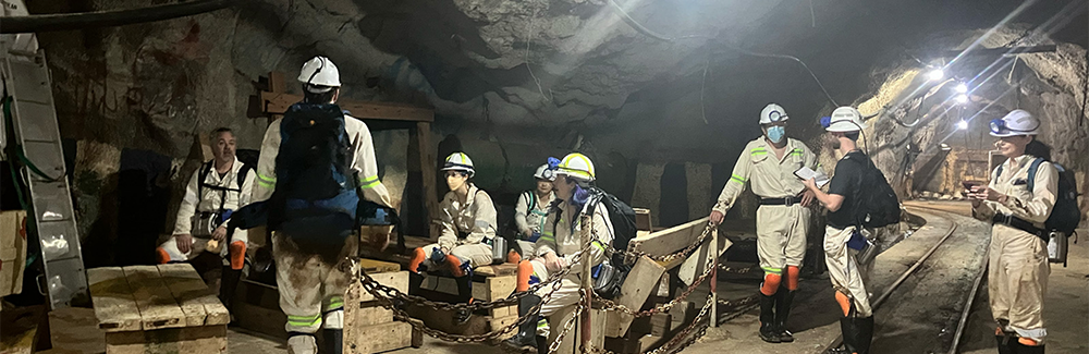 A group of scientists below ground in a mine 
