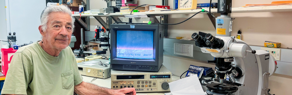 A scientist in front of a microscope