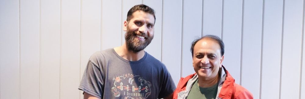 Two scientists, smiling 