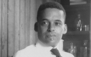 Ernest Everett Just with microscope. Credit MBL Archives