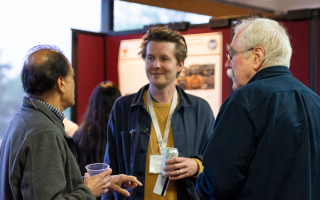 Header photo: MBL Director Nipam Patel (left) and Nobel Prize winner and Embryology alumnus Eric Weichaus (right) talk with a student during the poster session.