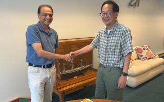 Nipam Patel (left) shaking hands with Mark Terasaki (right) 