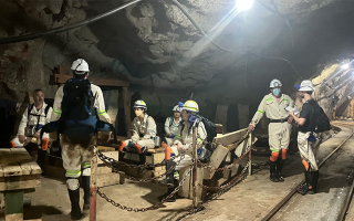 A group of scientists below ground in a mine 