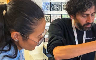 Two scientists prepare a sample in the lab
