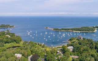 Aerial view of The Knob and Quissett Harbor in Woods Hole, with greater Buzzards Bay in the distance. 