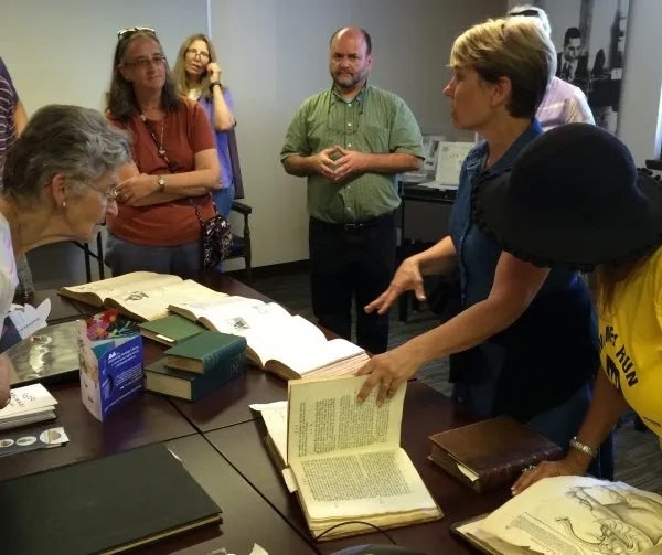 MBL Library Director Jen Walton (right) and Serials Librarian Matt Person (at rear) explain the Rare Books and Archives on display at the open house.
