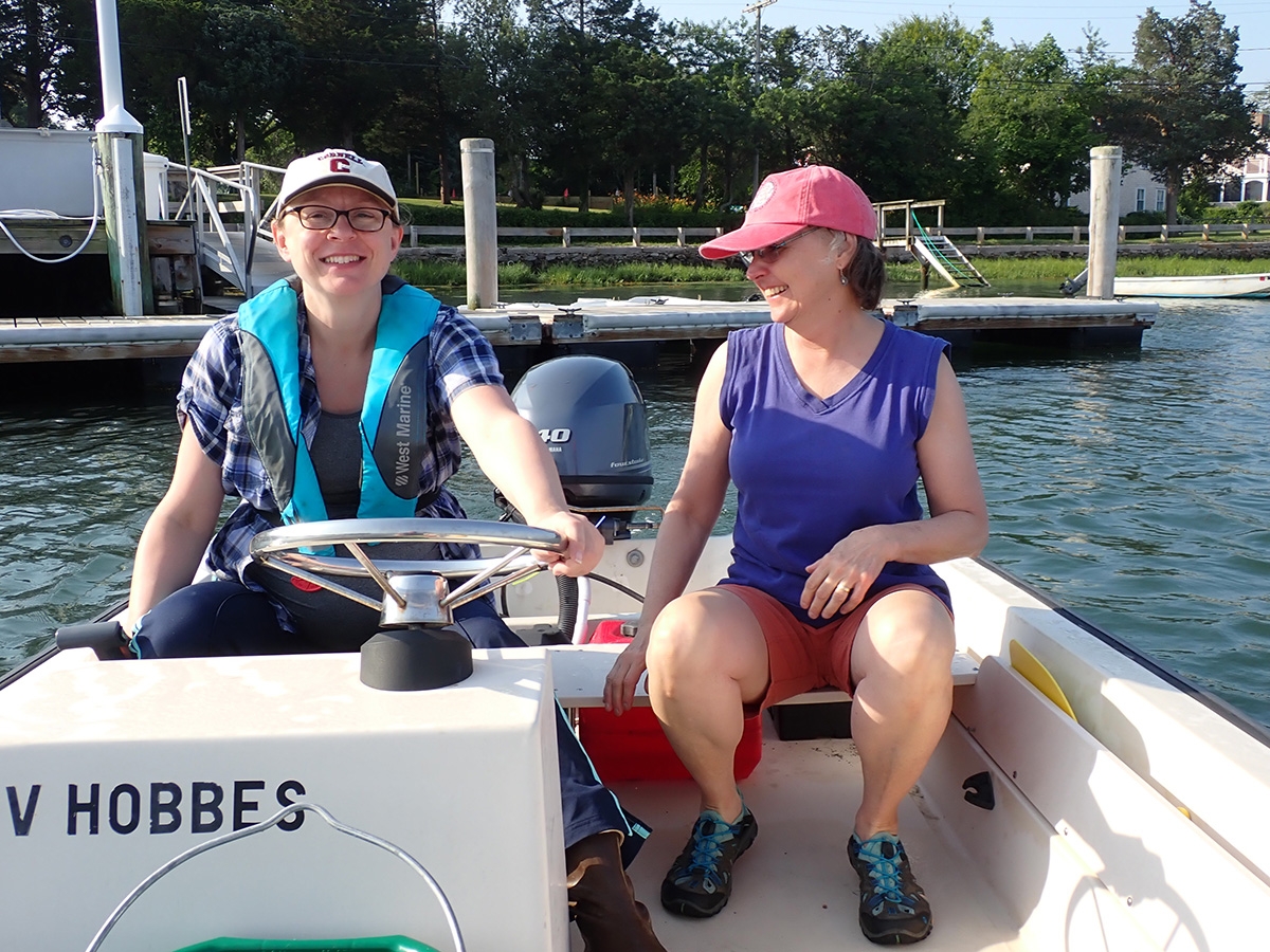 Melanie Hayn and Roxanne Marino from Cornell University deploying sampling equipment in West Falmouth Harbor. 