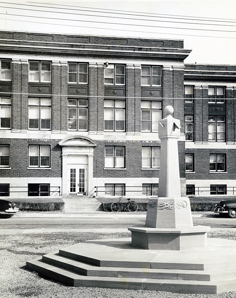 Yalden Sundial and Lillie building. A bike is visible in front of the building, as is part of a car..