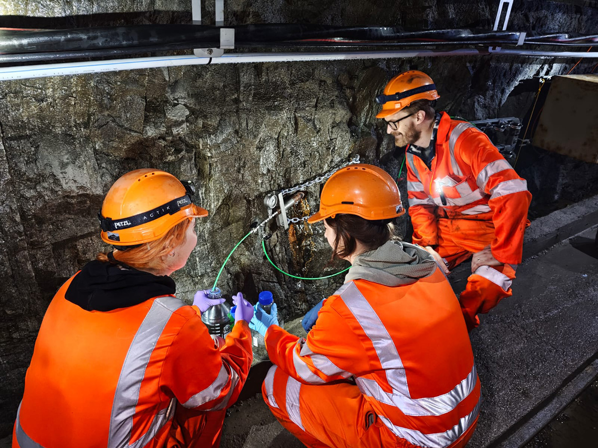 Three scientists sampling fracture fluids deep beneath the Gotthard massif in the Swiss Alps. 