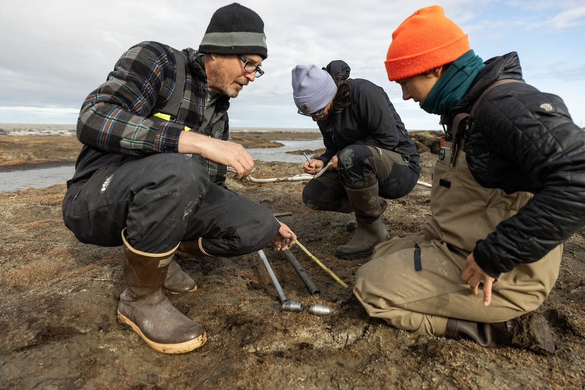 This photo shows three scientists doing fieldwork in Alaska. 