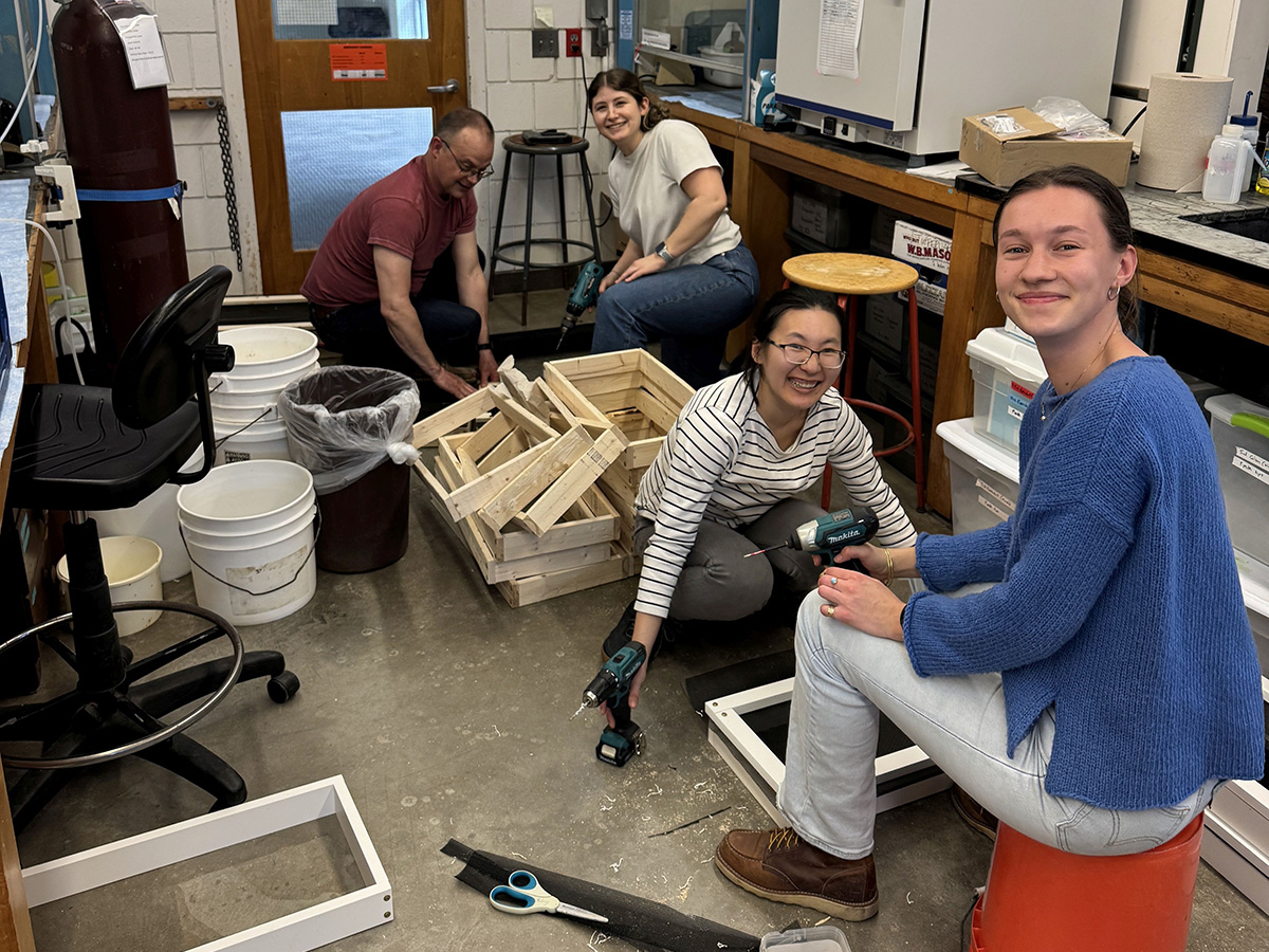 People assembling clam boxes at MBL.