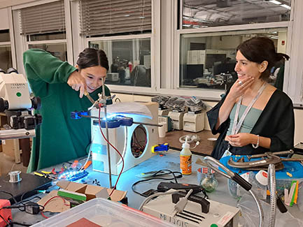 Two scientists building a speaker in a lab.