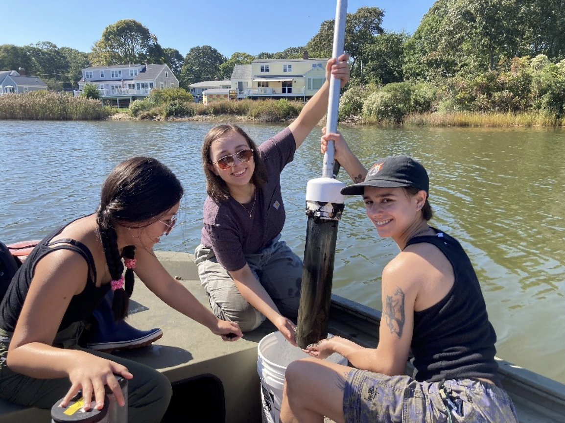 This photo shows three students on a boat.