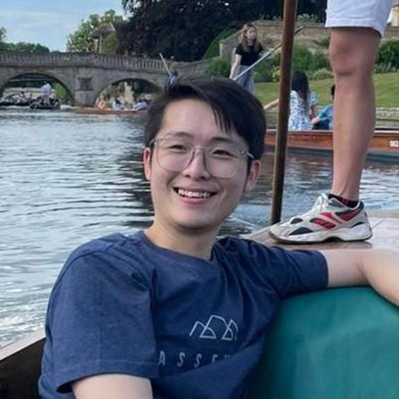 Male presenting person in a boat.