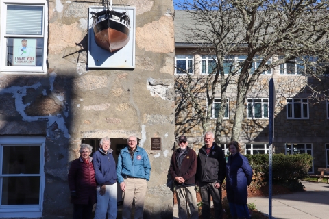 A group gathers to see the new plaque on MBL's Candle House building. Credit: Emily Greenhalgh