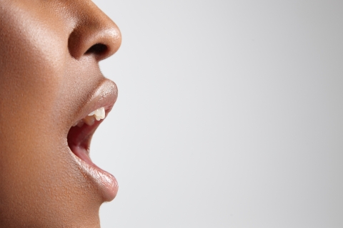 A stock image of a black woman with an open mouth.