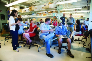scientists convening in a lab