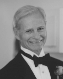 Black and white photo of man in tuxedo.