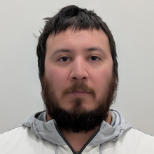 Male-presenting person with dark hair and short beard.