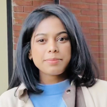 Female presenting person with shoulder length dark hair.