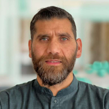 Male presenting person with short brown hair and beard.