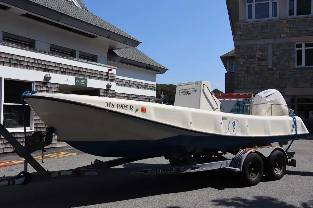 The newly-renovated Boston Whaler Outrage Hull #001 parked in front of the MBL Marine Resources Center in September 2021. Credit: Emily Greenhalgh, MBL